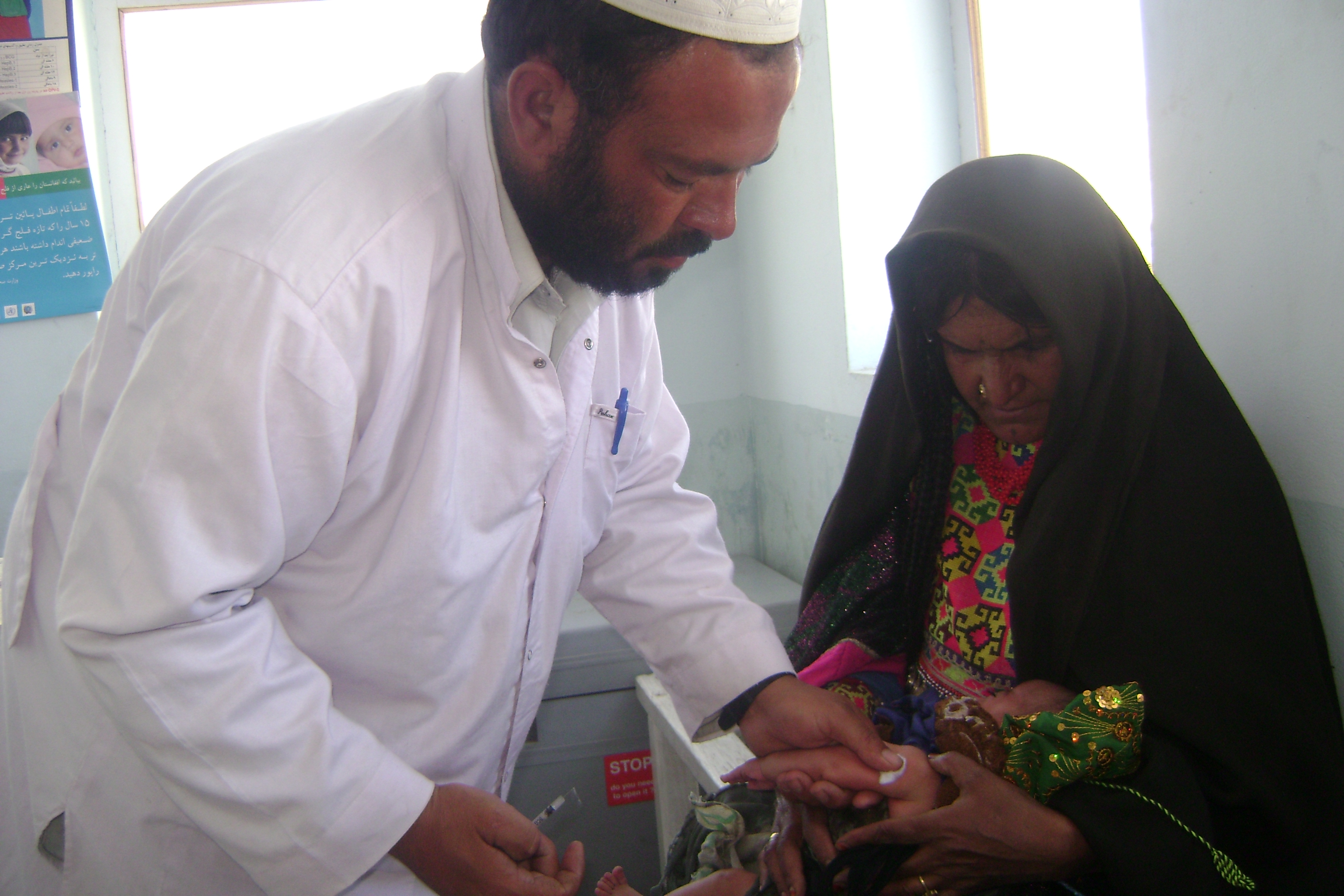 A doctor examining a baby to help us combat the infant mortality rate in Afghanistan.