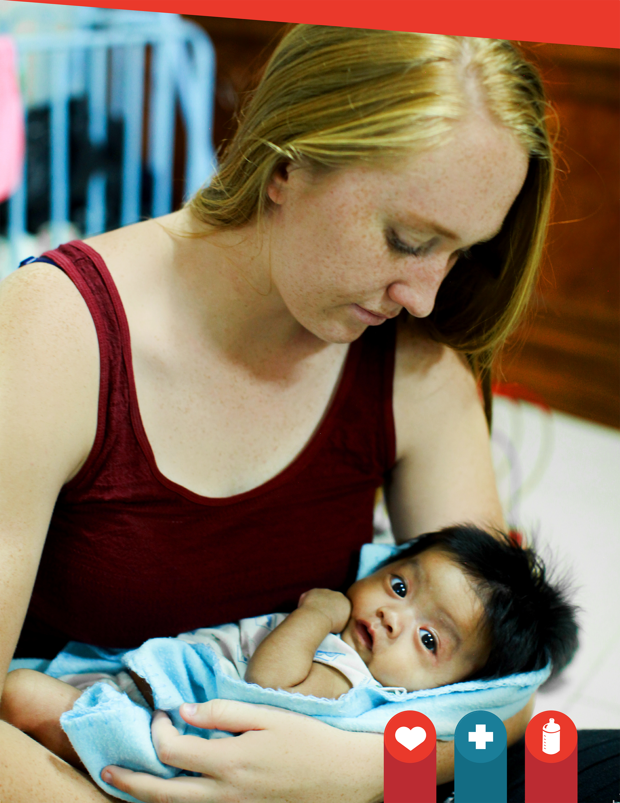 Woman holding a vulnerable infant wrapped in a blue blanket, showcasing care and support in a nurturing environment, relevant to Saving Moses' mission for children's welfare.