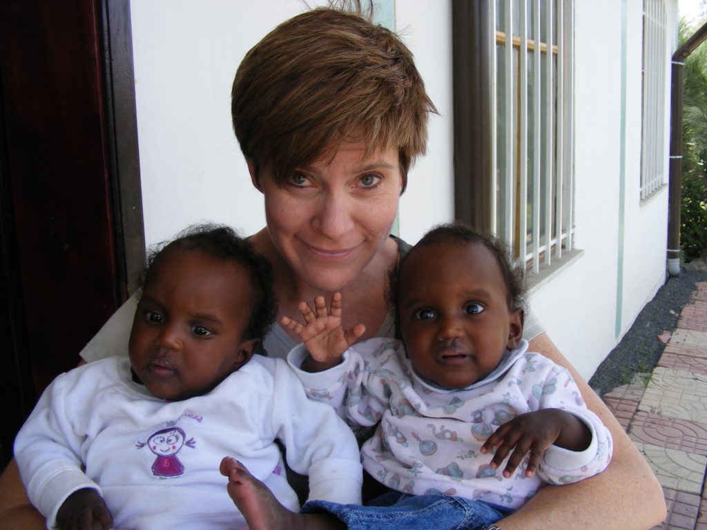 Founder Sarah Bowling holding abandoned twins Sarah and Ruth. Caring for babies where help is least available.
