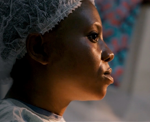 Profile of a pregnant woman wearing a surgical cap, symbolizing maternal health and support for vulnerable mothers in community birth education programs.