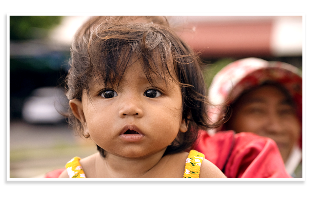 Child with expressive eyes and tousled hair, symbolizing vulnerability and innocence, in context of donation for child welfare through Saving Moses.