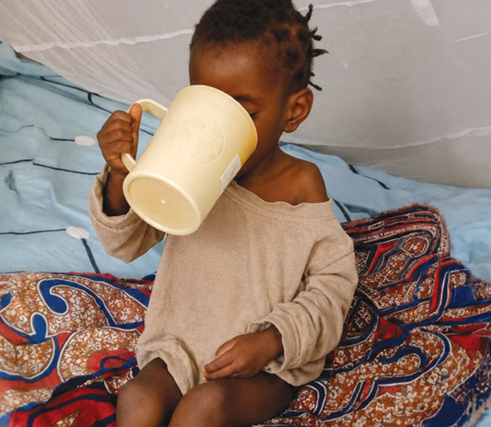 Ana drinking therapeutic milk at the hospital
